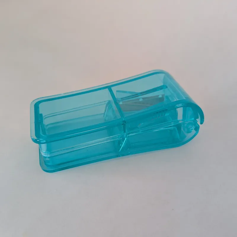 A closed blue translucent pill splitter and cutter tool for precise supplement dosing.