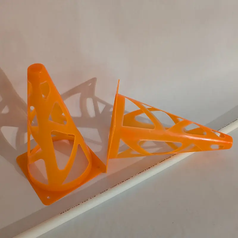 Two orange plastic agility cones for dog training.