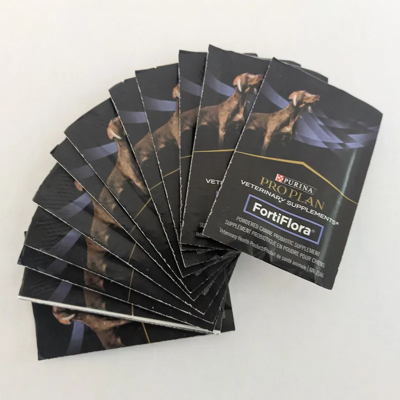 A fan-out of several individual 1-gram FortiFlora probiotic powder sachets.