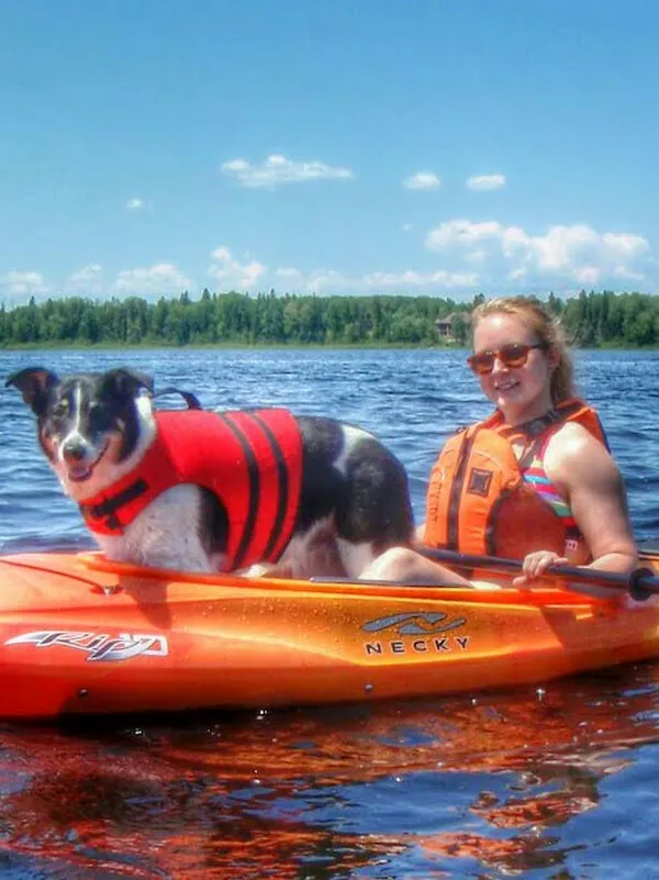 A polaroid photo of Maya in a red lifejacket on a kayak with Kayla.