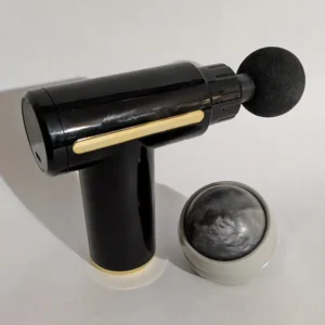 Black percussive massage gun and a grey manual roller ball for canine physical therapy.