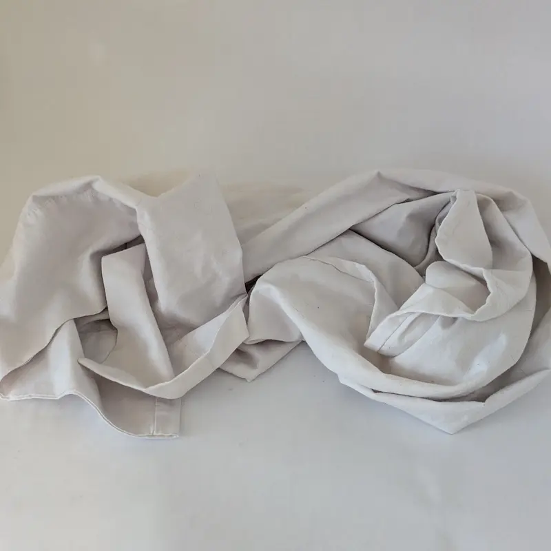 A soft, white cotton body pillowcase suitable for use as a dog mobility sling.