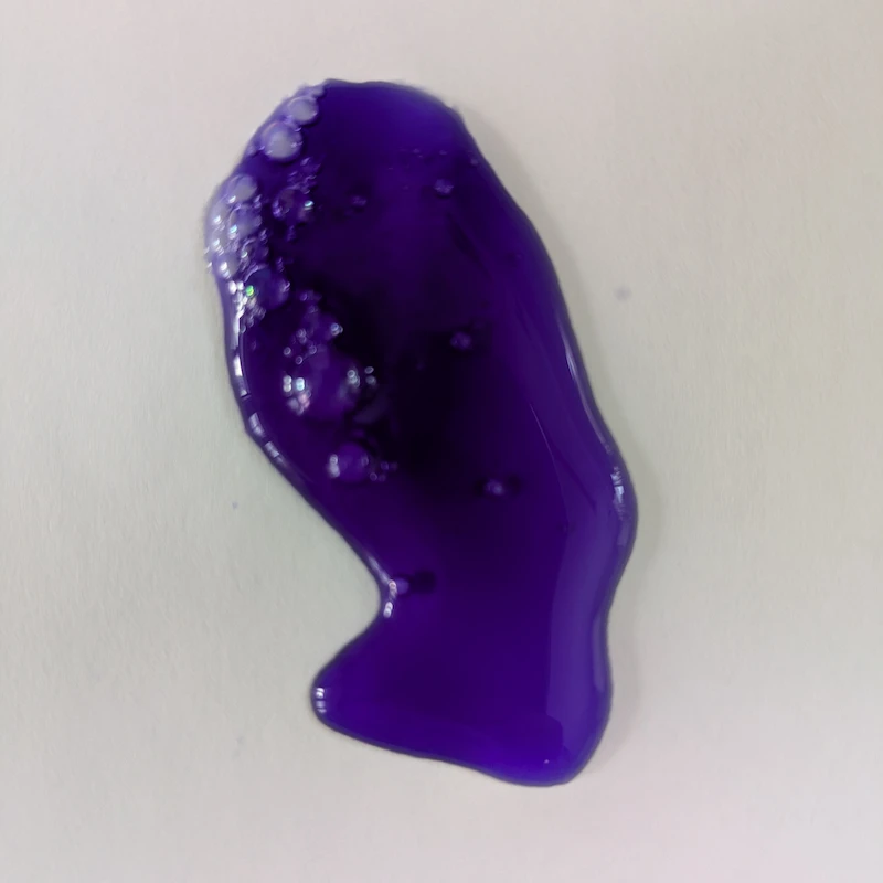 Close-up of the deep purple pigment of TUX whitening shampoo for brightening white dog fur.